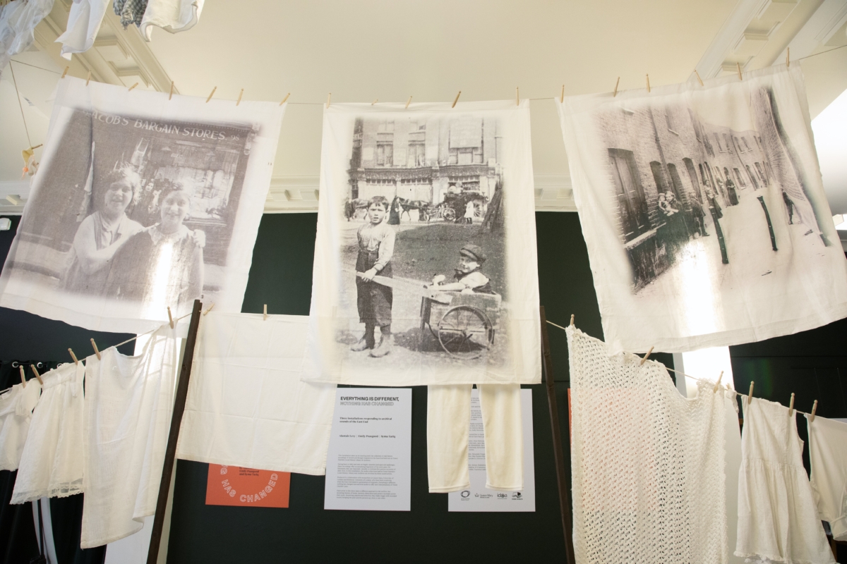 There are lines of laundy in the entrance to the archives, containing images of children in the East London back streets of the 1930s to 1950s.